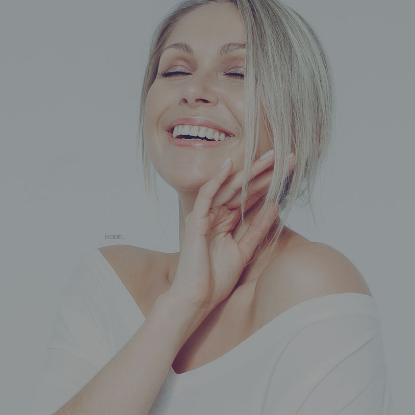 woman smiling with her eyes closed, J plasma