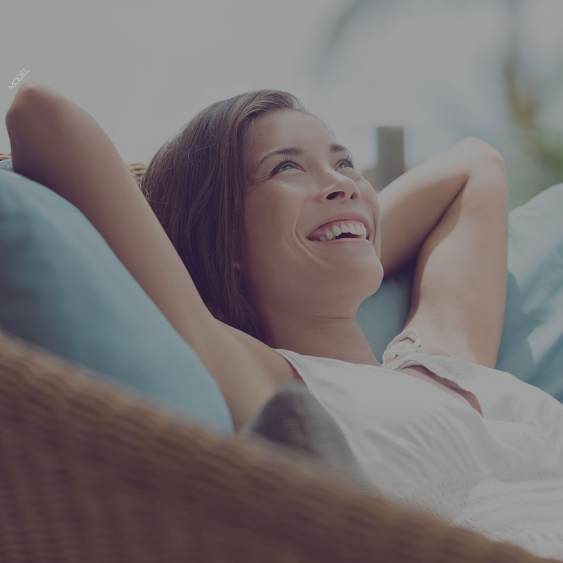 Happy woman laying back on a couch